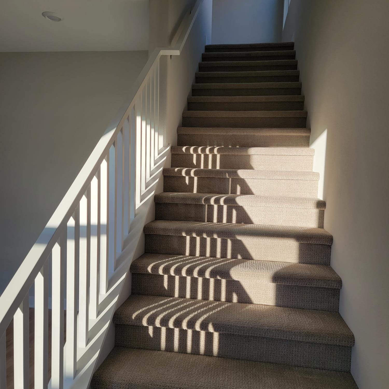 Wood stair treads installed over a straight staircase