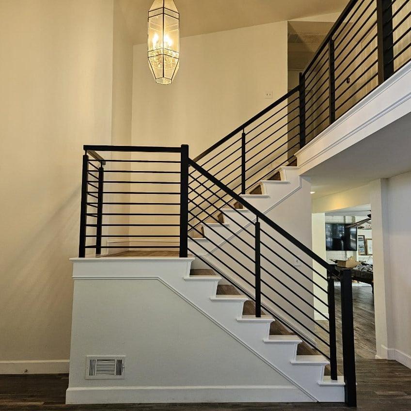 Refinished stair treads with painted risers in an entryway