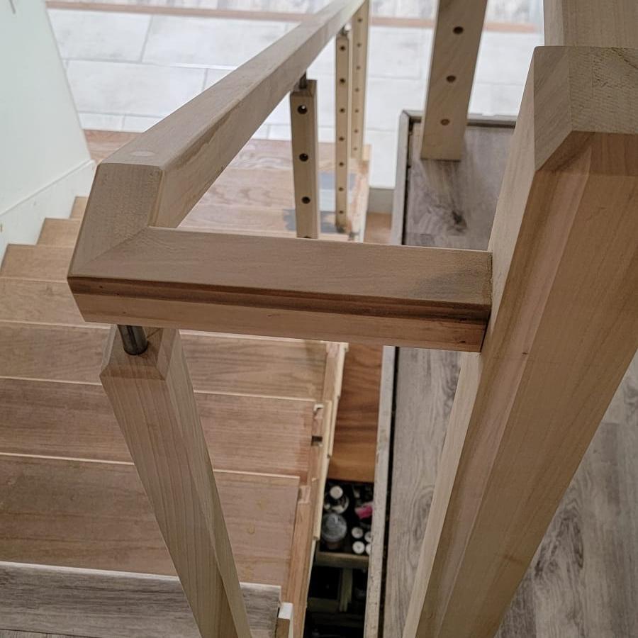Iron and wood staircase railing in a remodeled home