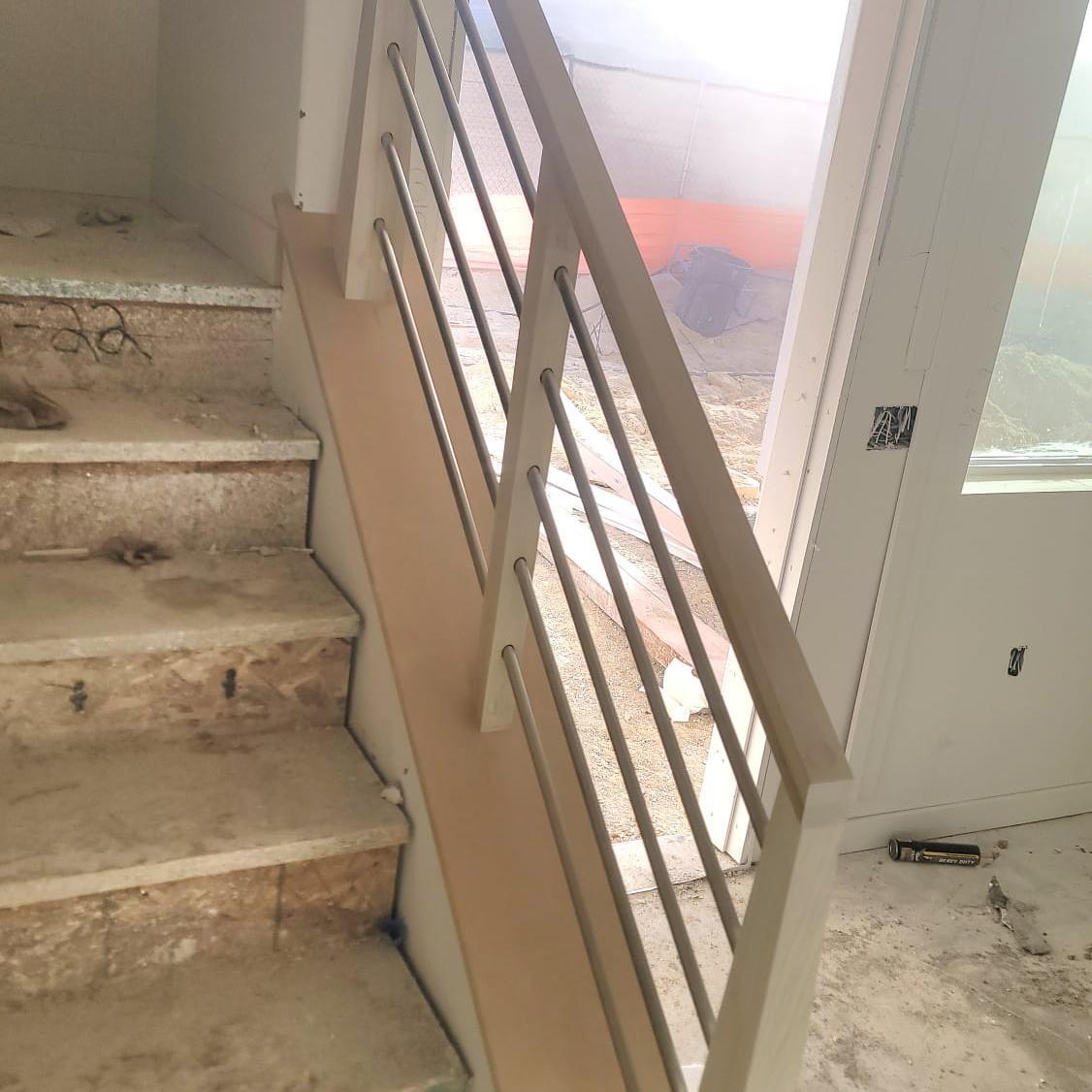 Entry foyer staircase with refinished wood treads